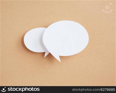 paper speech bubbles on brown background