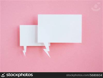 paper speech bubbles on pink background
