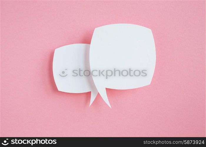 paper speech bubbles on pink background