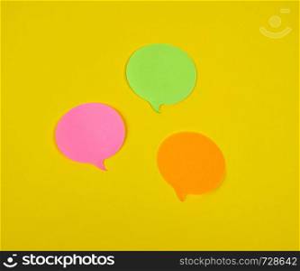 paper sticky cloud-shaped stickers on a yellow background, close up