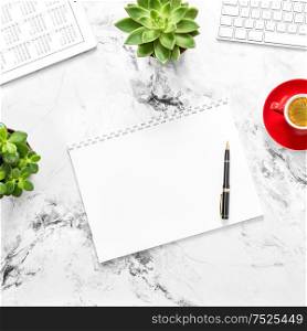 Paper, tablet pc with calendar, coffee, succulent plants on working desk. Flat lay
