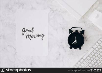paper with good morning text alarm clock diary milk carton keyboard desk