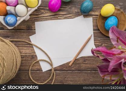 papers near set easter eggs thread fresh flower