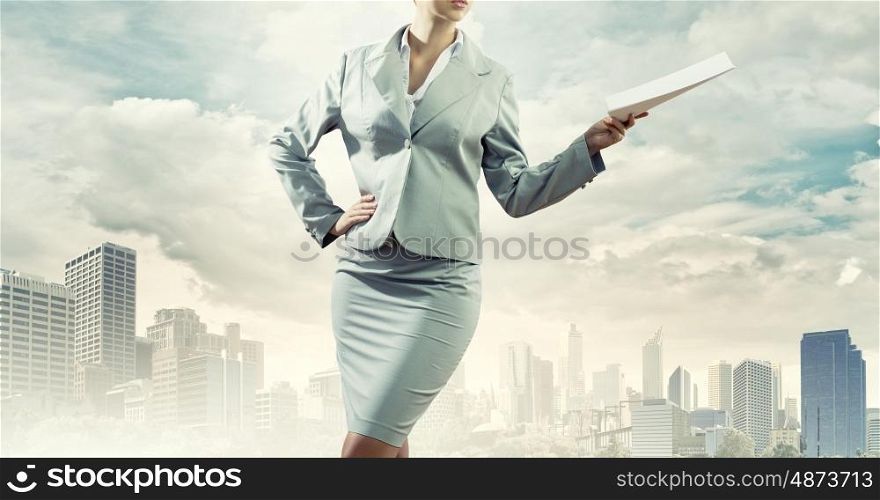 Paperwork. Close up of businesswoman holding papers in hands