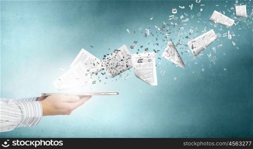 Paperwork. Tablet pc in businessmans hand and papers flying of screen