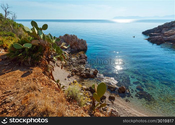 Paradise sea bay with azure water and beach. View from coastline trail of Zingaro Nature Reserve Park, between San Vito lo Capo and Scopello, Trapani province, Sicily, Italy.