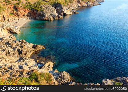 Paradise sea bay with azure water and beach. View from coastline trail of Zingaro Nature Reserve Park, between San Vito lo Capo and Scopello, Trapani province, Sicily, Italy.