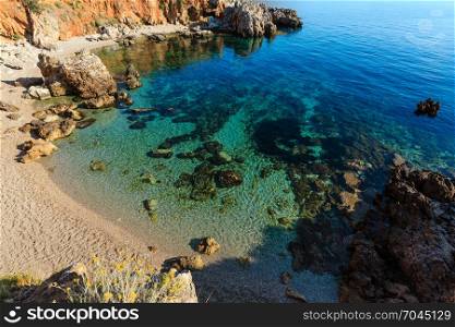 Paradise sea bay with azure water and beach. View from coastline trail of Zingaro Nature Reserve Park, Trapani province, Sicily, Italy.