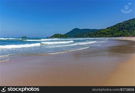 Paradise tropical beach surrounded by preserved rainforest and mountains in Bertioga on the coast of the state of Sao Paulo. Paradise tropical beach surrounded by preserved rainforest and mountains