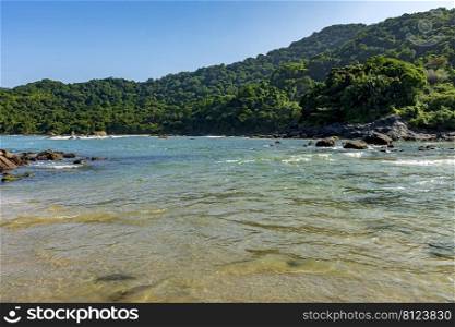 Paradise tropical beach with mountains and forests around in coastal Bertioga of Sao Paulo state, Brazil. Paradise tropical beach with mountains and forests around