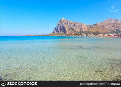 Paradise Tyrrhenian sea bay, San Vito lo Capo beach with clear azure water and extremal white sand, and Monte Monaco in far, Sicily, Italy. People unrecognizable.