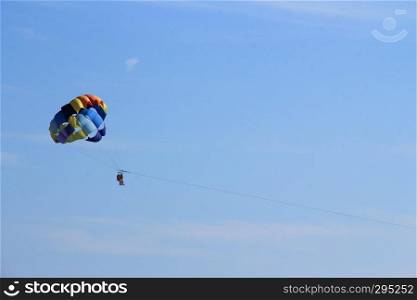 Paraglider couple on the sky above the sea
