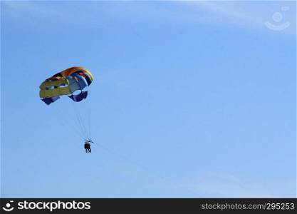 Paraglider couple on the sky above the sea