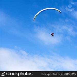Paraglider flies paraglider in the sky. Paragliding.