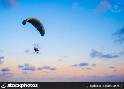 paraglider flying on the sky at sunset