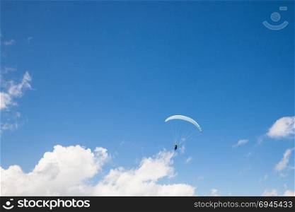 Paraglider flying. Paraglider flying on the deep blue sky