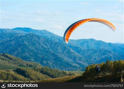Paragliding in Altai mountains. Paragliders in fight in the mountains, concept of extreme sport activity.. Paragliding in mountains