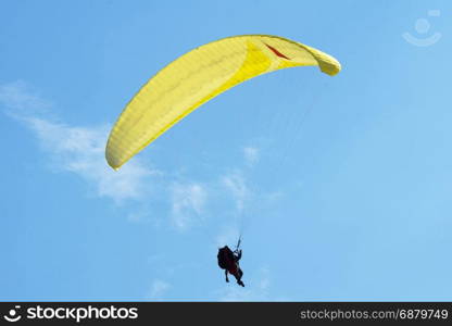 Paragliding in Denmark over the against clear blue sky