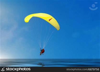 Paragliding in Denmark over the against clear blue sky