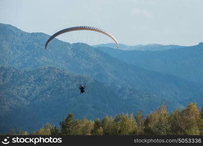 Paragliding in mountains. Paragliding in mountains. Para gliders in fight in the mountains, extreme sport activity.