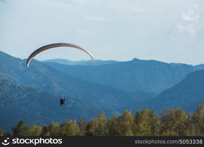 Paragliding in mountains. Paragliding in mountains. Para gliders in fight in the mountains, extreme sport activity.