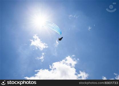 Paragliding sport. Paraglider at the blue sunny sky