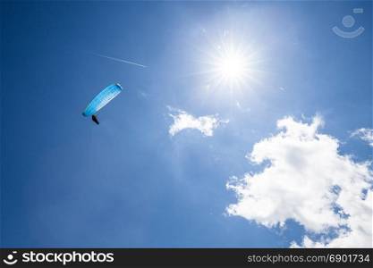 Paragliding sport. Paraglider at the blue sunny sky