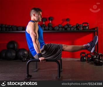 Parallettes man parallel bars workout exercise at red gym