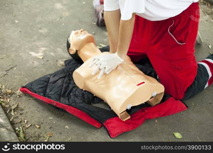 Paramedic demonstrates CPR on dummy