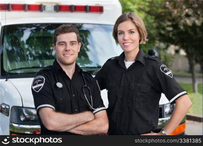 Paramedic team portrait standing in front of ambulance