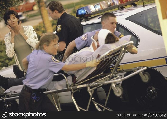 Paramedics putting a patient into an ambulance