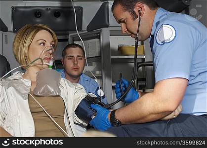 Paramedics taking care of victim in ambulance