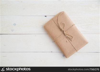 parcel,gift Packed in eco-friendly paper on light wooden background. the view from the top