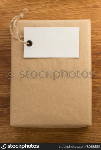 parcel wrapped packaged box on wooden background