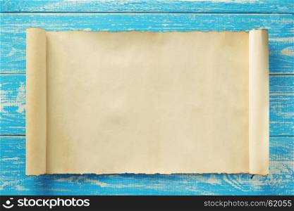parchment scroll at old wooden background