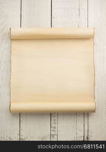 parchment scroll on wooden background