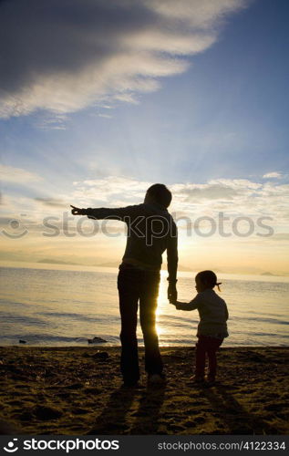 Parent and child on beach