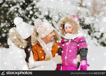 parenthood, fashion, season and people concept - happy family with child in winter clothes outdoors. happy family with child in winter clothes outdoors