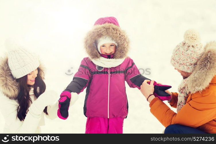 parenthood, fashion, season and people concept - happy family with child in winter clothes outdoors. happy family with child in winter clothes outdoors