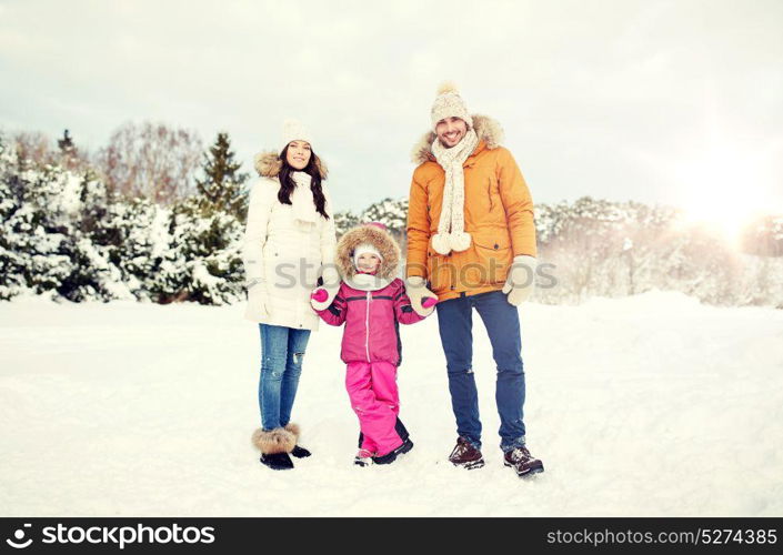 parenthood, fashion, season and people concept - happy family with child in winter clothes outdoors. happy family with child in winter clothes outdoors