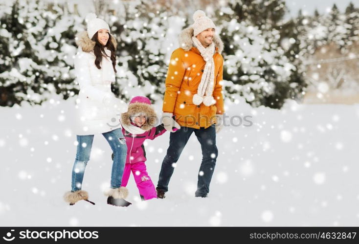 parenthood, fashion, season and people concept - happy family with child in winter clothes walking outdoors