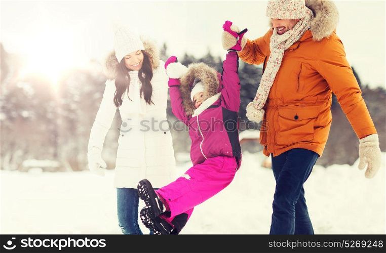 parenthood, fashion, season and people concept - happy family with child in winter clothes walking outdoors. happy family in winter clothes walking outdoors