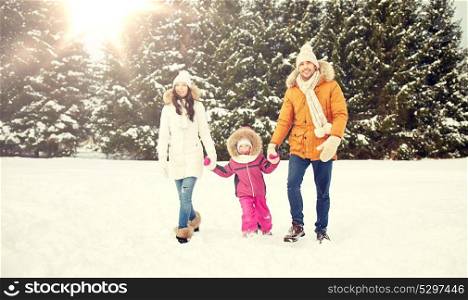 parenthood, fashion, season and people concept - happy family with child in winter clothes walking outdoors. happy family in winter clothes walking outdoors