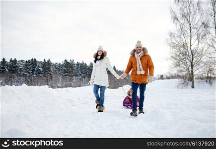 parenthood, fashion, season and people concept - happy family with child on sled walking in winter outdoors
