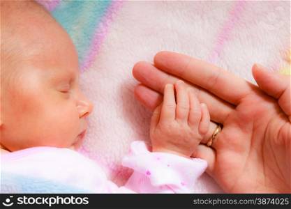 parenting and love concept. Closeup tiny hand the sleeping baby girl in the palm of mother
