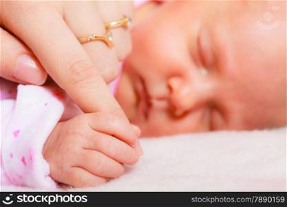 parenting and love concept. Closeup tiny hand the sleeping baby girl in the palm of mother