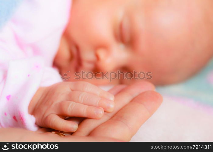 parenting and love concept. Closeup tiny hand the sleeping baby girl in the palm of mother