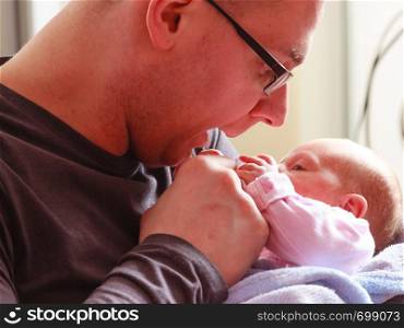 Parenting and love concept. Father holding and taking care of little newborn baby. Father holding taking care of newborn baby