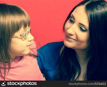 Parenting, childhood concept. Family portrait photo of mother and little toddler daughter with eyeglasses. Family photo of mother and toddler daughter