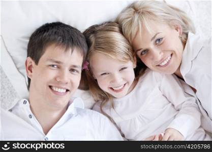 Parents and child in a white close-up